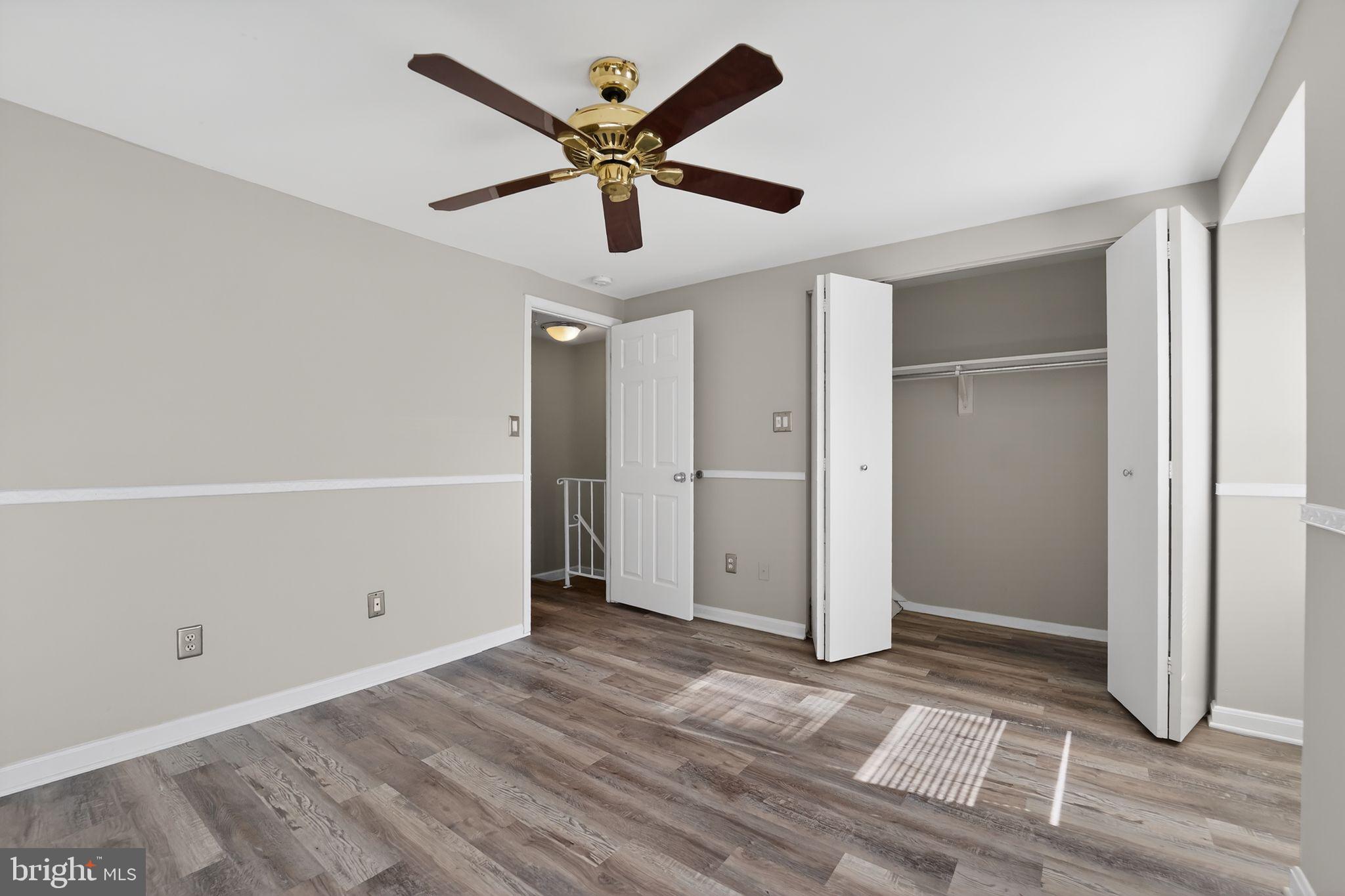 14 Pickens Court Baltimore, MD 21236 - Photo 18 of 30 a view of a big room with wooden floor and a ceiling fan