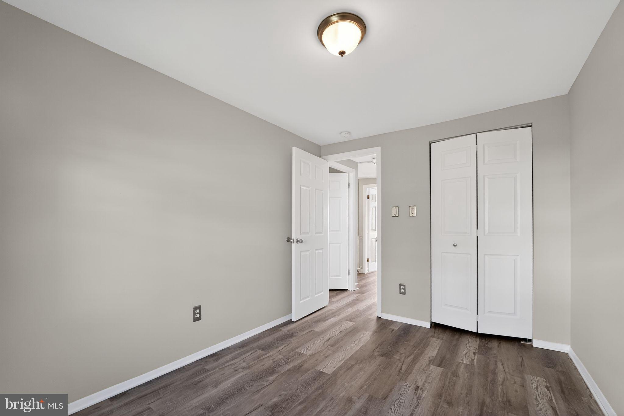 14 Pickens Court Baltimore, MD 21236 - Photo 21 of 30 a view of an empty room with wooden floor