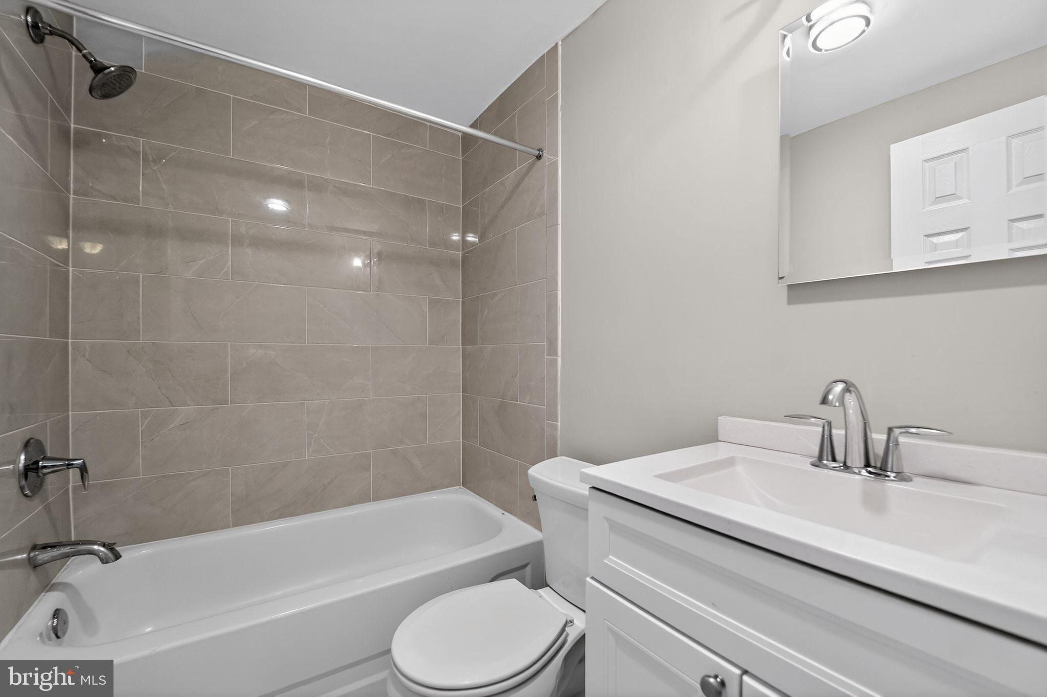 14 Pickens Court Baltimore, MD 21236 - Photo 24 of 30 a bathroom with a sink a toilet and a bathtub