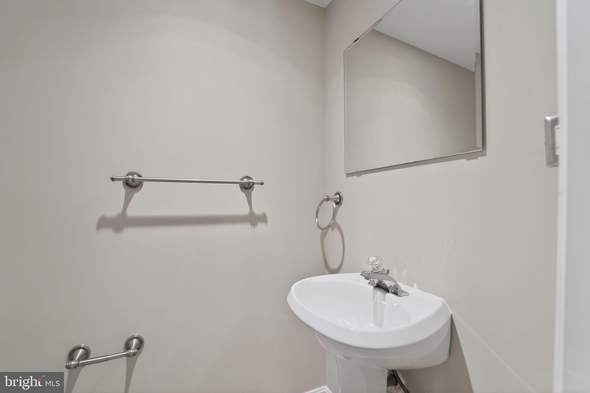 14 Pickens Court Baltimore, MD 21236 - Photo 26 of 30 a bathroom with a sink and a mirror