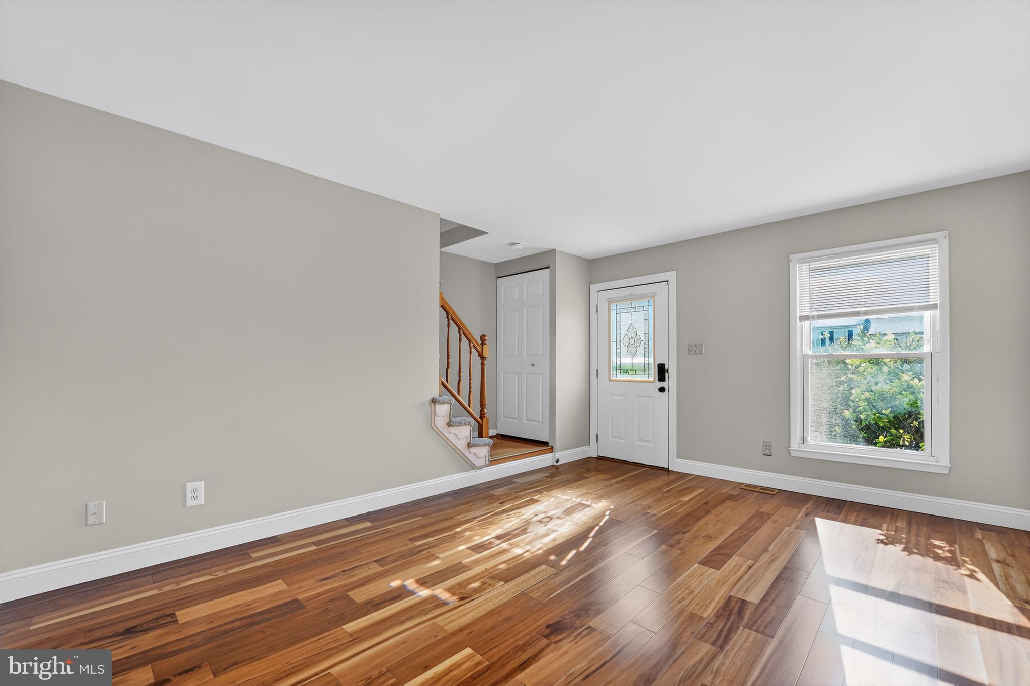 14 Pickens Court Baltimore, MD 21236 - Photo 3 of 30 a view of an empty room with wooden floor and a window