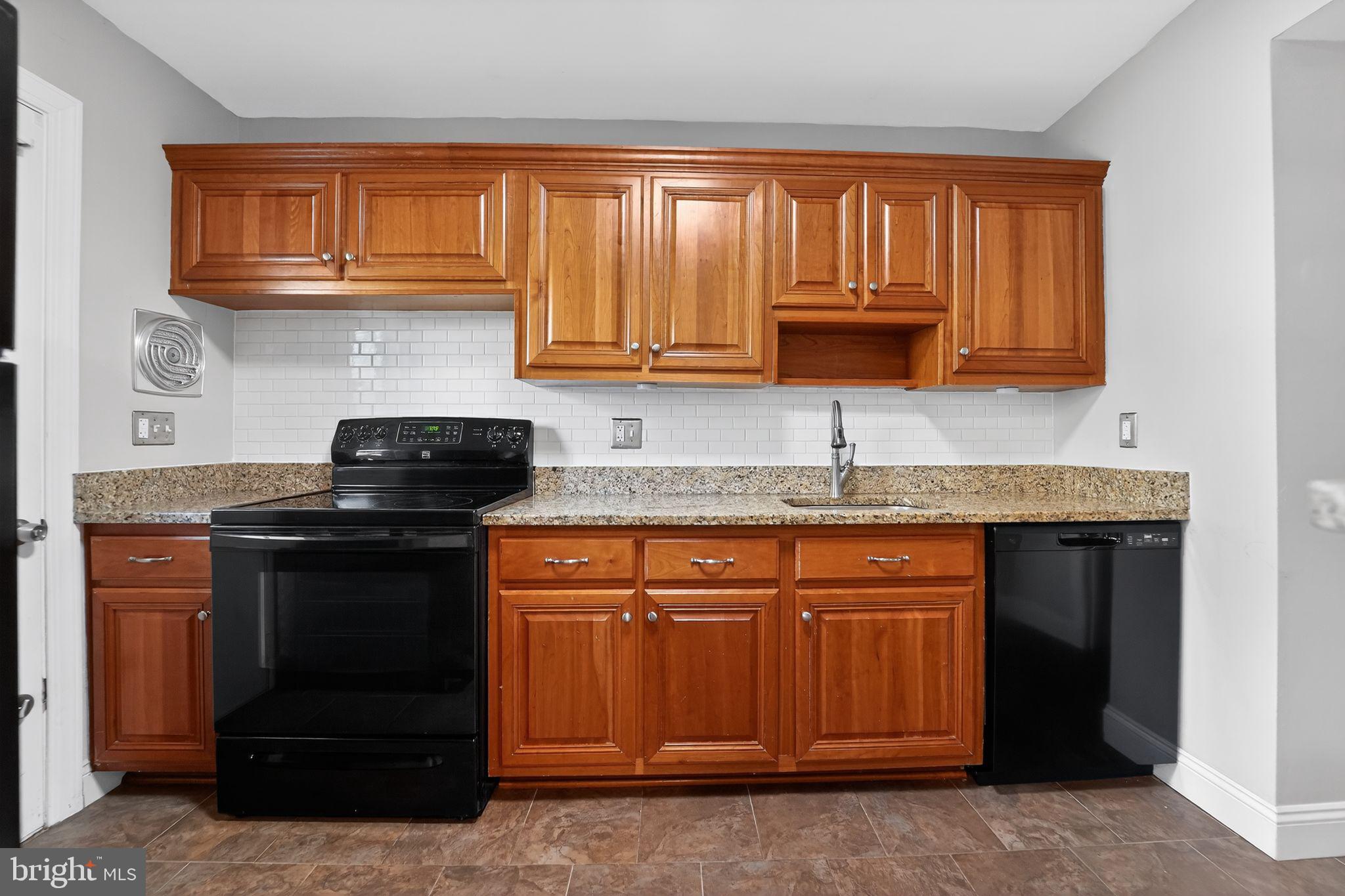 14 Pickens Court Baltimore, MD 21236 - Photo 9 of 30 a kitchen with stainless steel appliances granite countertop a stove a sink and a microwave