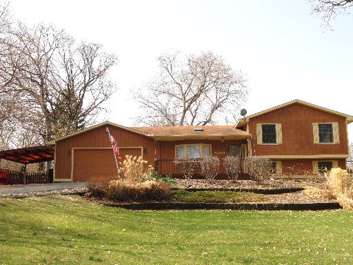 28461 West Treetop Road Ingleside, IL 60041 - Photo 1 of 1 a front view of a house with a yard and garage
