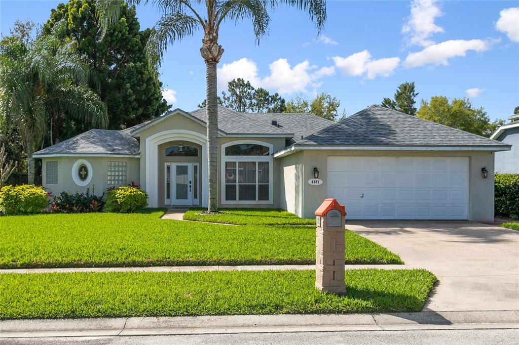 1371 Broken Pine Road Deltona, FL 32725 - Photo 1 of 1 a front view of a house with a yard and garage