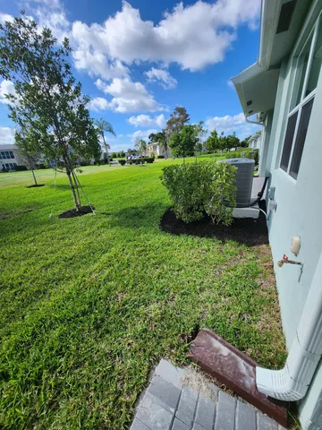 a view of a garden with a house