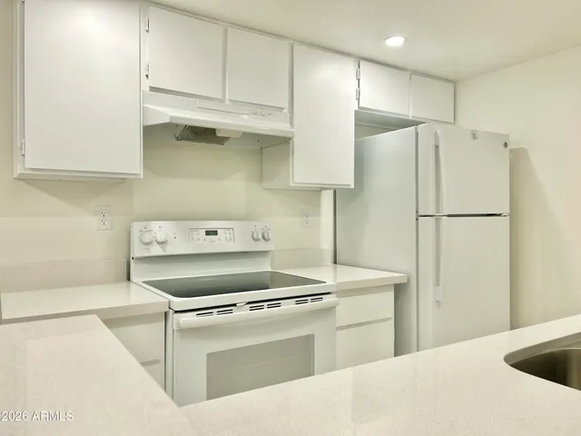 a kitchen with cabinets and stainless steel appliances