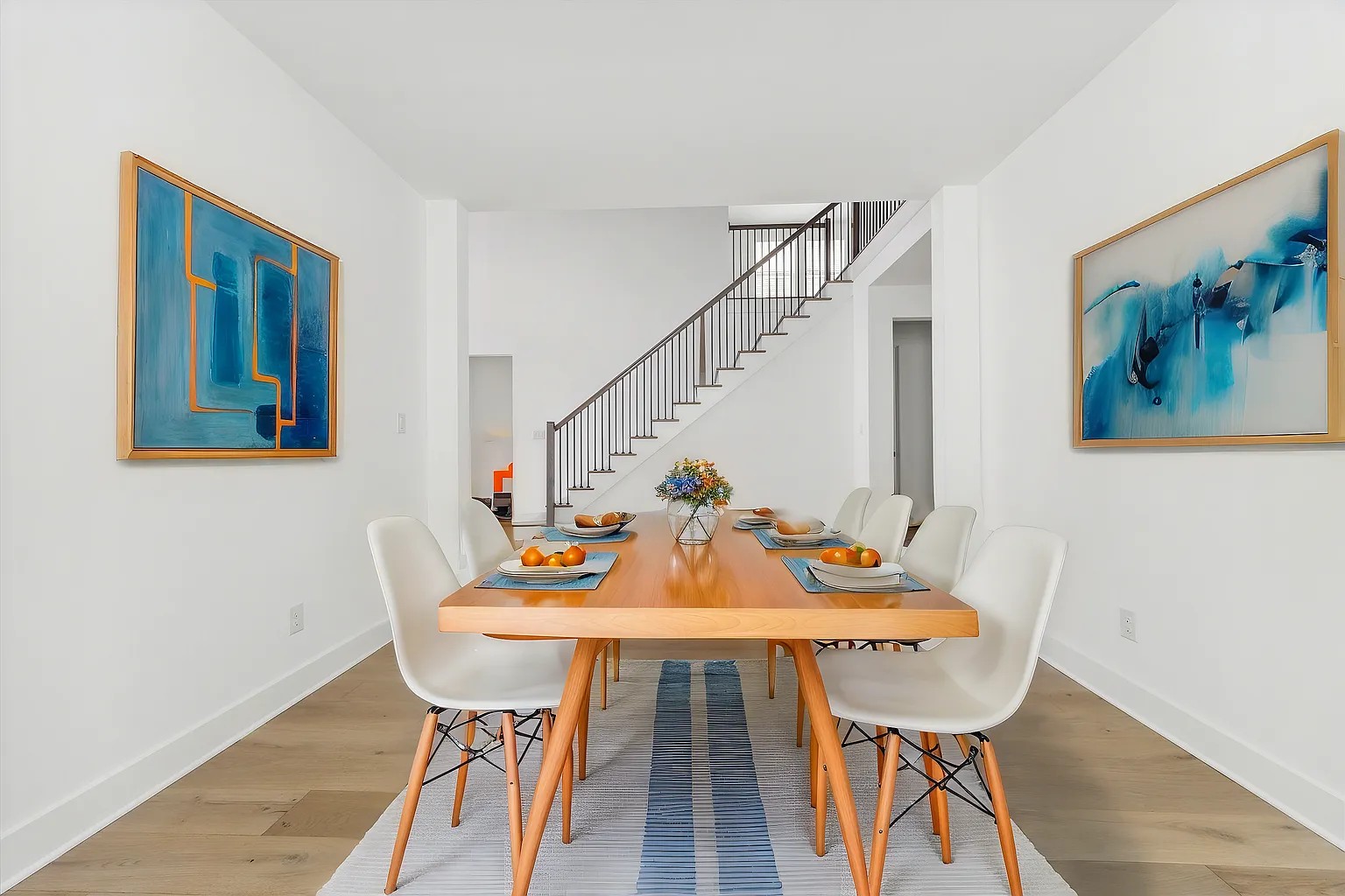 1909 Varese Path Leander, TX 78641 - Photo 5 of 40 Clean lines define this bright dining room with elegant wood flooring and a striking open staircase.