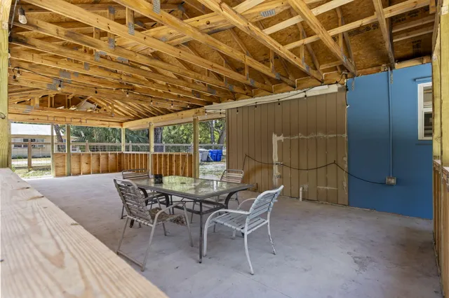 a view of a roof deck with table and chairs