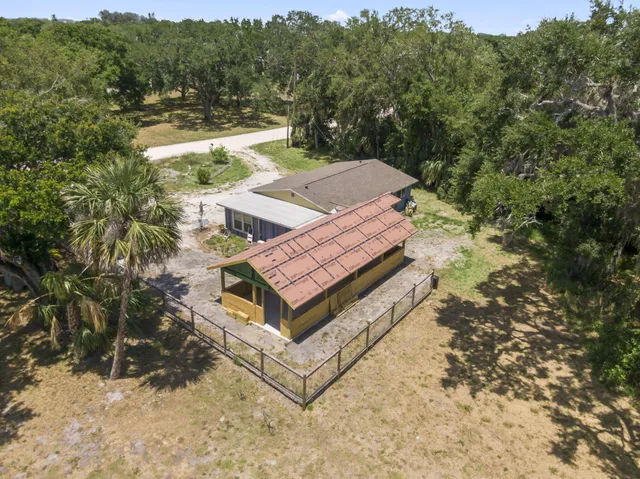 a view of a small house with a yard