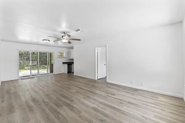 wooden floor in an empty room with a window