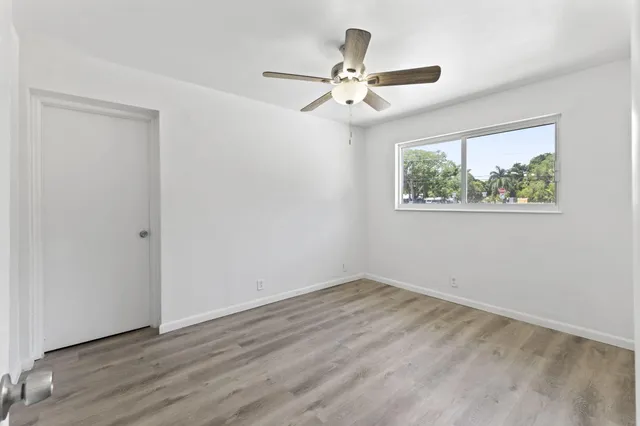 a view of a room with wooden floor closet and windows
