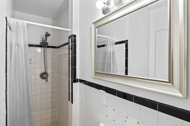 a bathroom with a shower and a mirror