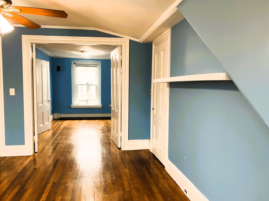 66 Maple Street, Unit 3 Boston, MA 02136 - Photo 5 of 14 a view of an empty room with wooden floor and a window