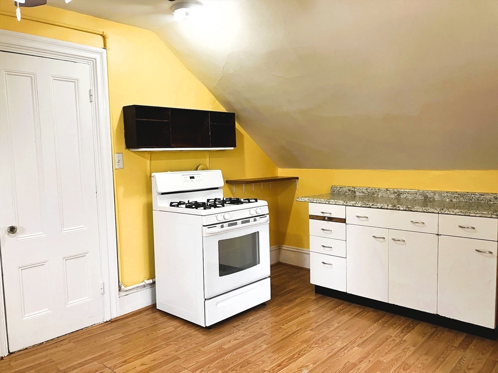 66 Maple Street, Unit 3 Boston, MA 02136 - Photo 8 of 14 a view of washer and dryer with wooden floor
