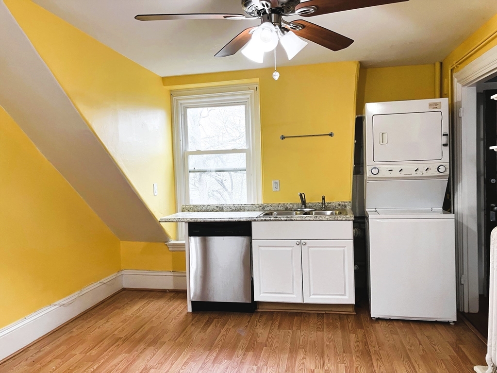 66 Maple Street, Unit 3 Boston, MA 02136 - Photo 10 of 14 a kitchen with a sink wooden floor and a window