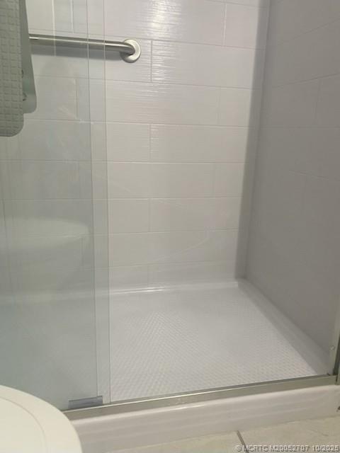 1939 Southwest Palm City Road, Unit G Stuart, FL 34994 - Photo 13 of 34 a bathroom with a shower