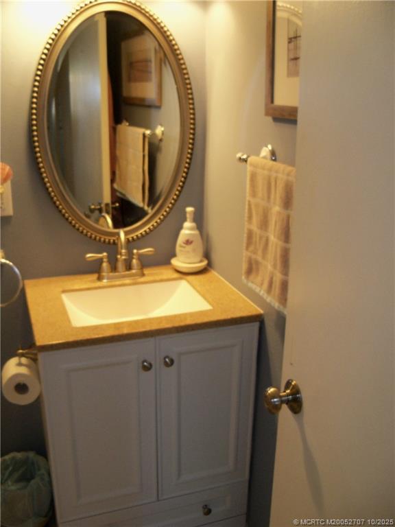 1939 Southwest Palm City Road, Unit G Stuart, FL 34994 - Photo 15 of 34 a bathroom with a sink and a mirror