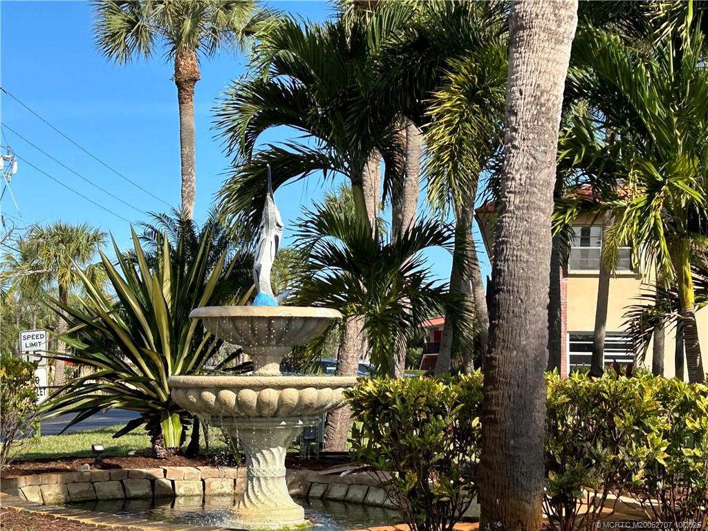 1939 Southwest Palm City Road, Unit G Stuart, FL 34994 - Photo 25 of 34 a view of a palm trees in front of a building