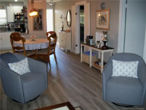 a dining room with furniture and wooden floor