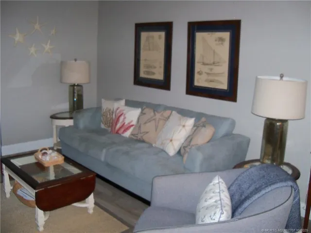 a living room with furniture and a lamp