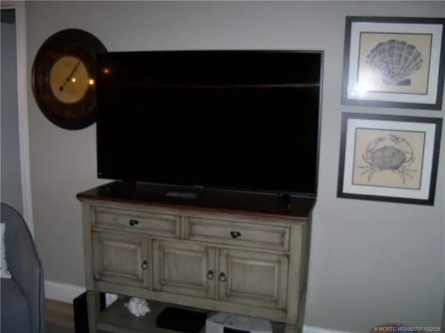 a kitchen with a cabinets and a black refrigerator