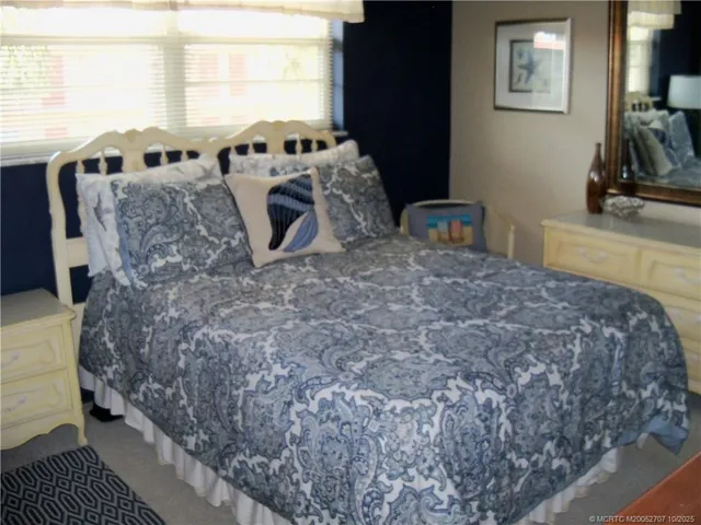 a bed sitting in a room next to a window