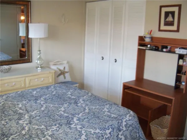 a bedroom with a bed and a mirror