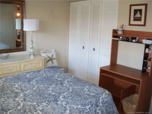 a bedroom with a bed and a mirror