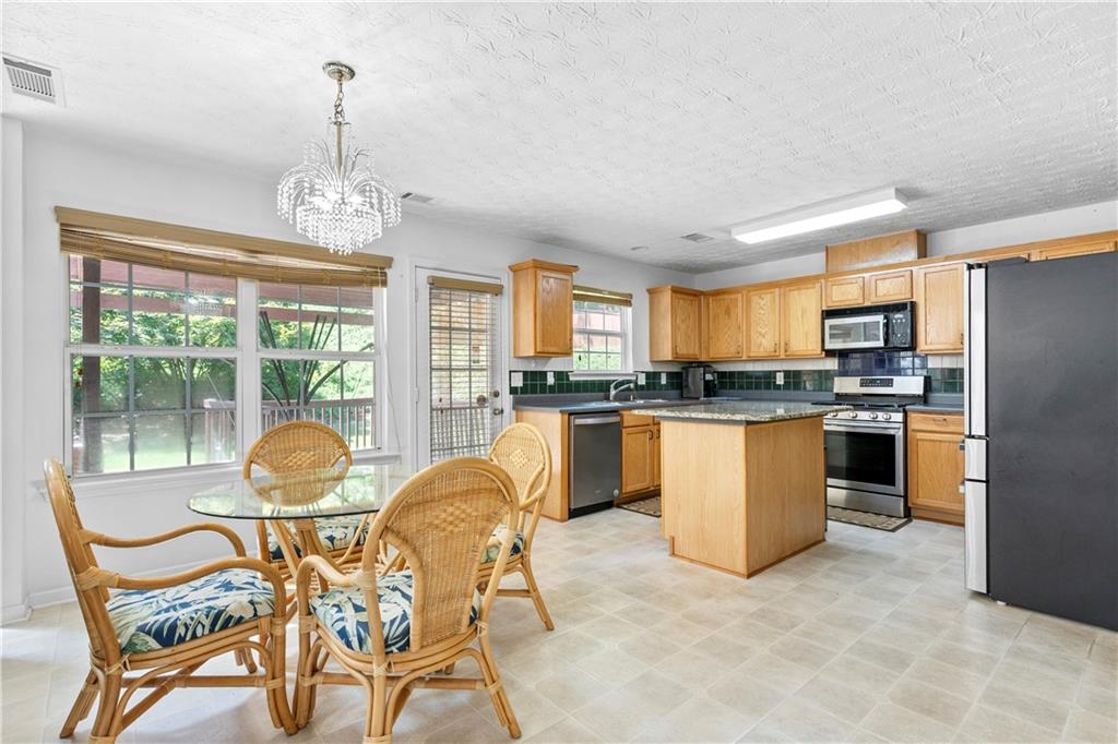 665 Roxford Lane Northeast Buford, GA 30518 - Photo 6 of 19 a view of a dining room with furniture window and outside view