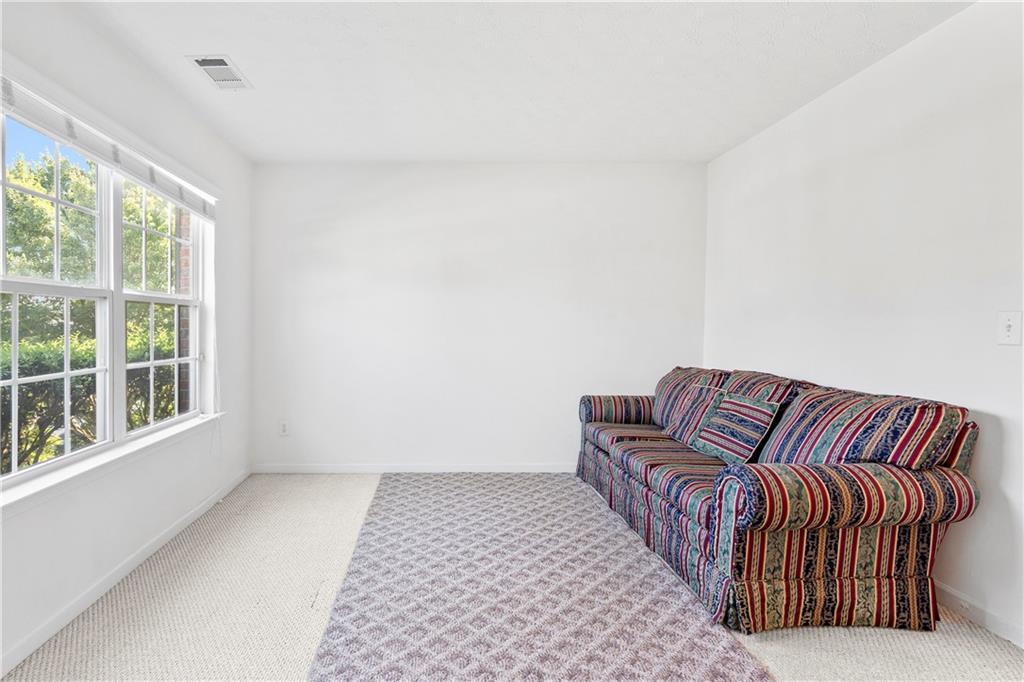 665 Roxford Lane Northeast Buford, GA 30518 - Photo 8 of 19 a living room with a couch and a large window
