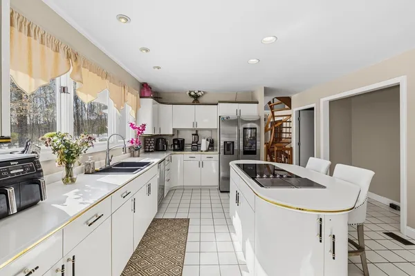 a living room with furniture a flat screen tv and a floor to ceiling window