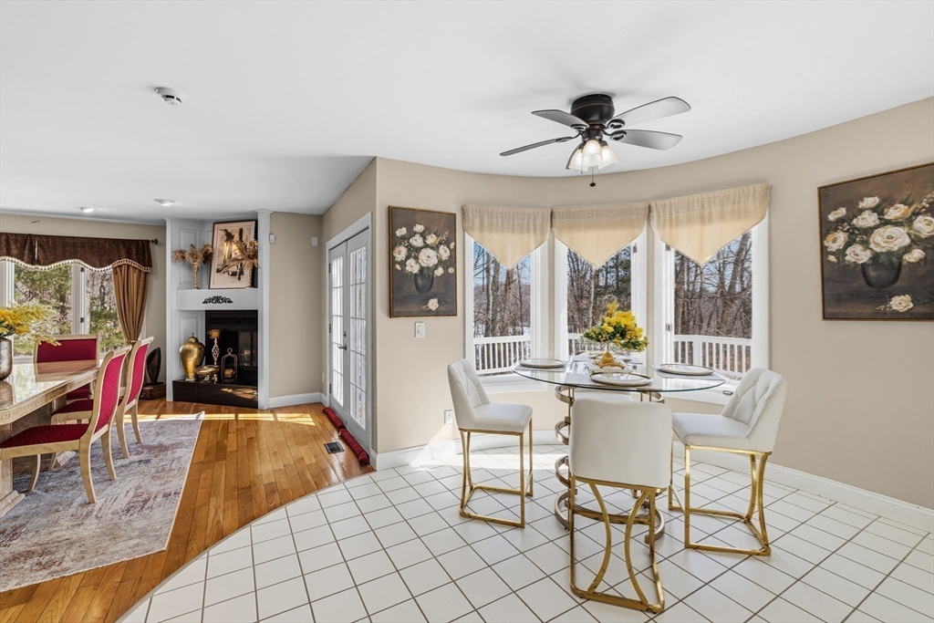 95 Ramshorn Road Dudley, MA 01571 - Photo 13 of 42 a living room with furniture a flat screen tv and a floor to ceiling window
