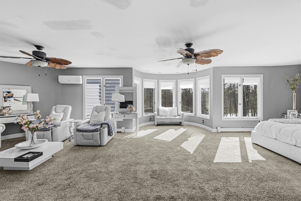 95 Ramshorn Road Dudley, MA 01571 - Photo 20 of 42 a living room with furniture a large window and a chandelier