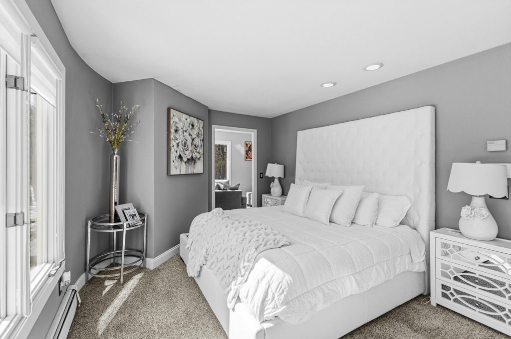 95 Ramshorn Road Dudley, MA 01571 - Photo 22 of 42 a bedroom with a bed and a lamp on table