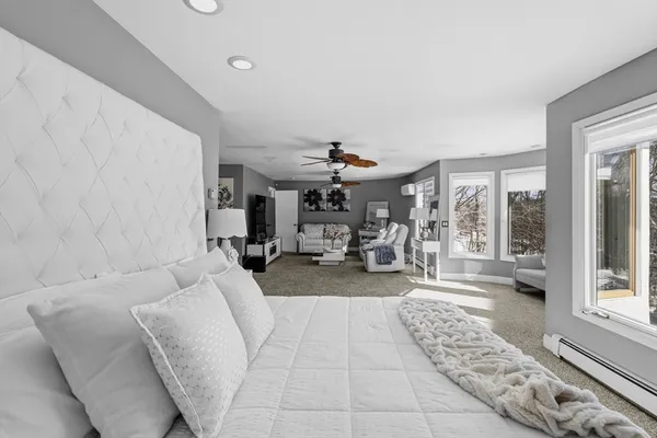 a bathroom with a tub sink and mirror