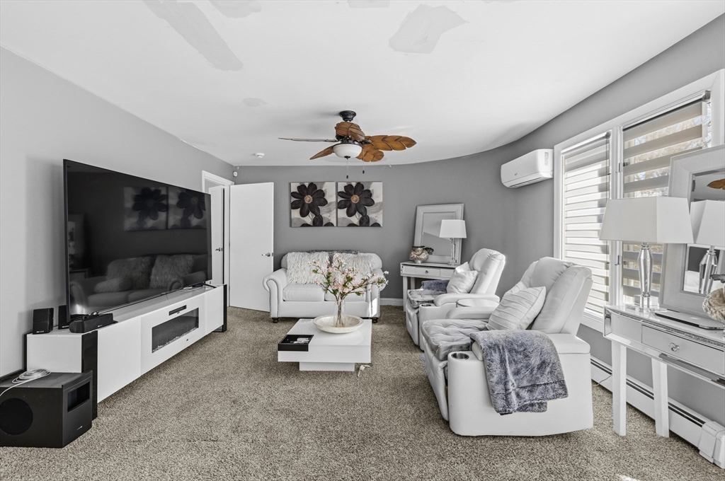 95 Ramshorn Road Dudley, MA 01571 - Photo 24 of 42 a living room with furniture and a flat screen tv