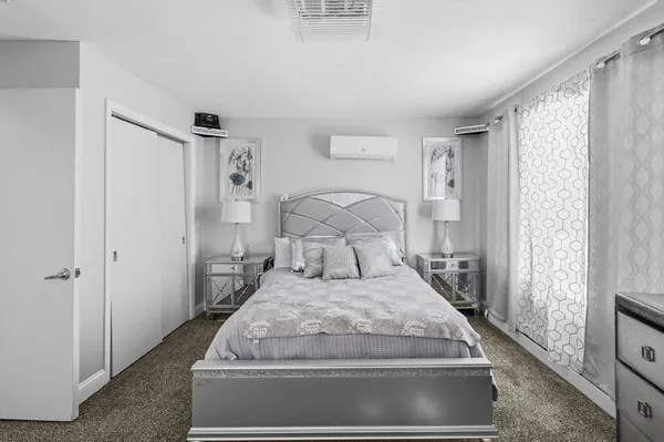 a bedroom with a bed and a chandelier