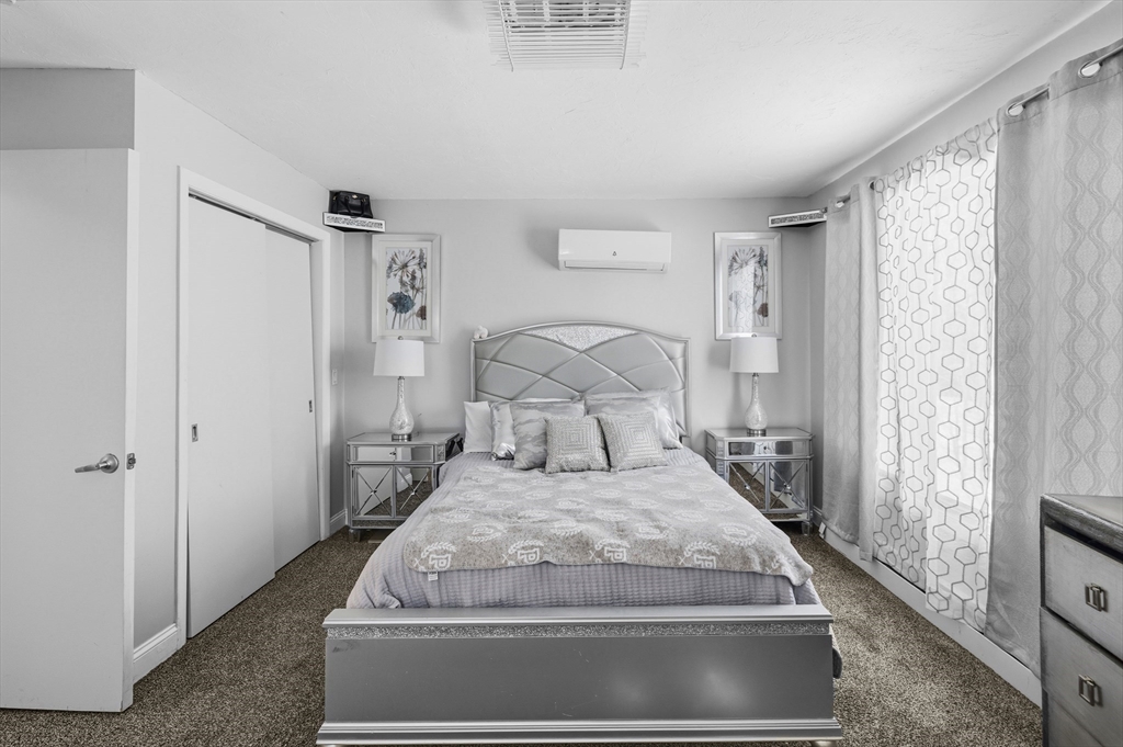 95 Ramshorn Road Dudley, MA 01571 - Photo 27 of 42 a large bed sitting in a bedroom next to a window