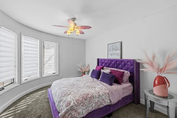 a living room with furniture tv and wooden floor