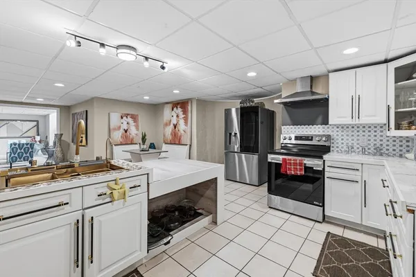 a living room with stainless steel appliances kitchen island granite countertop furniture and a kitchen view