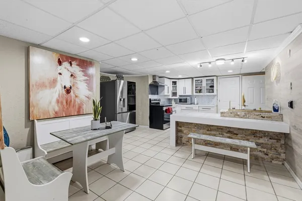 a living room with furniture a flat screen tv and a large window