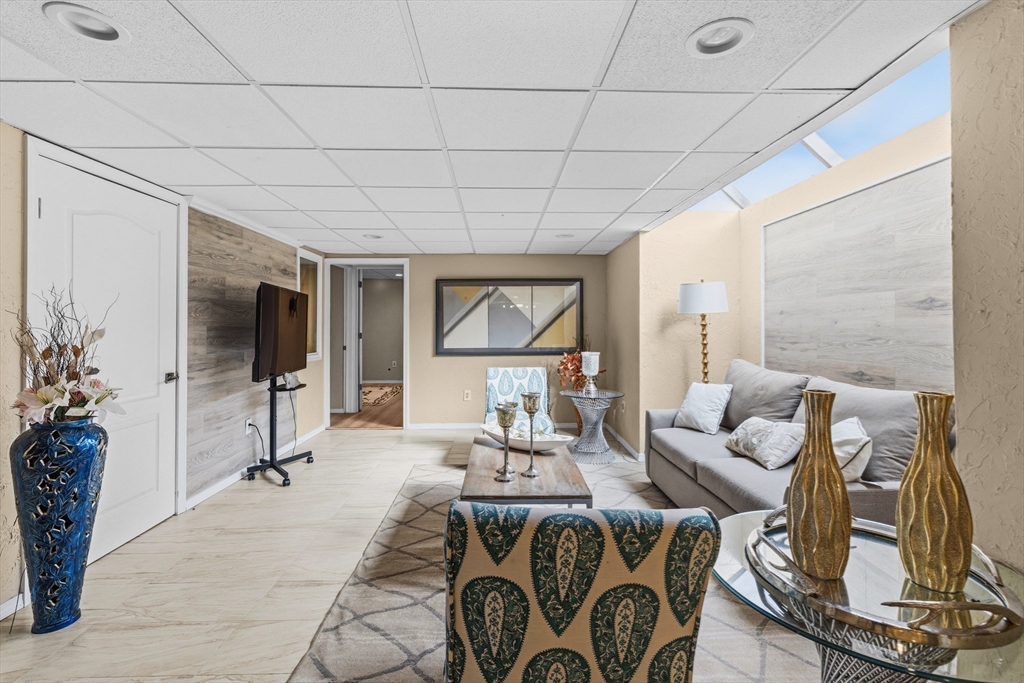 95 Ramshorn Road Dudley, MA 01571 - Photo 38 of 42 a living room with furniture a flat screen tv and a large window