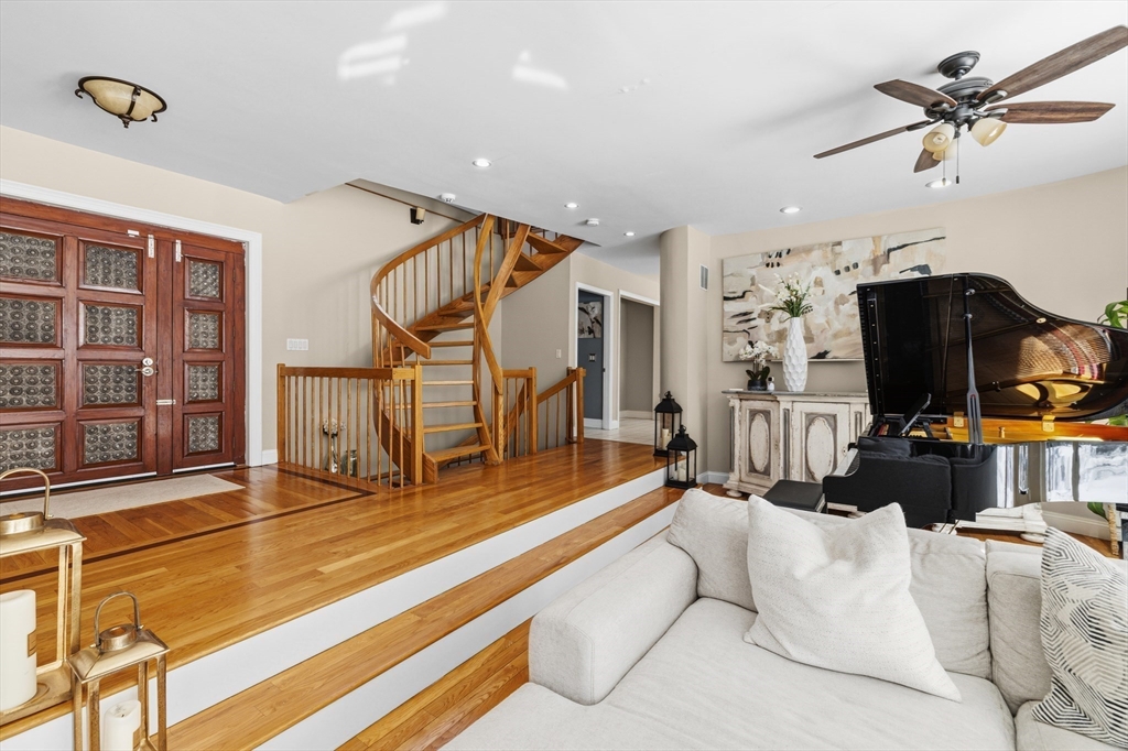 95 Ramshorn Road Dudley, MA 01571 - Photo 4 of 42 a living room with furniture gym equipment and a chandelier