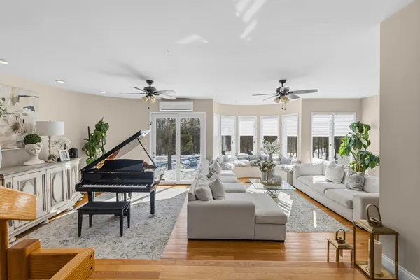 a living room with furniture and a wooden floor