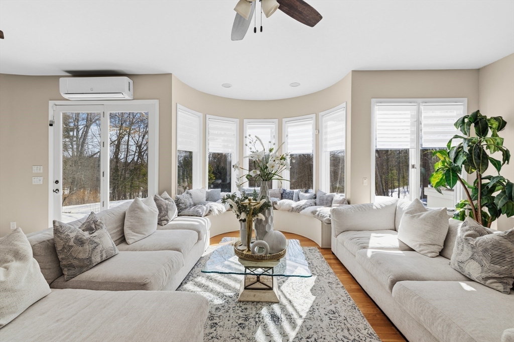 95 Ramshorn Road Dudley, MA 01571 - Photo 7 of 42 a living room with furniture large windows and wooden floor