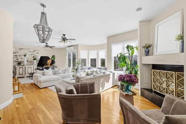 a living room with furniture and a chandelier