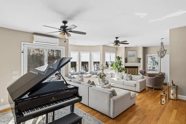 a living room with furniture a chandelier and a floor to ceiling window