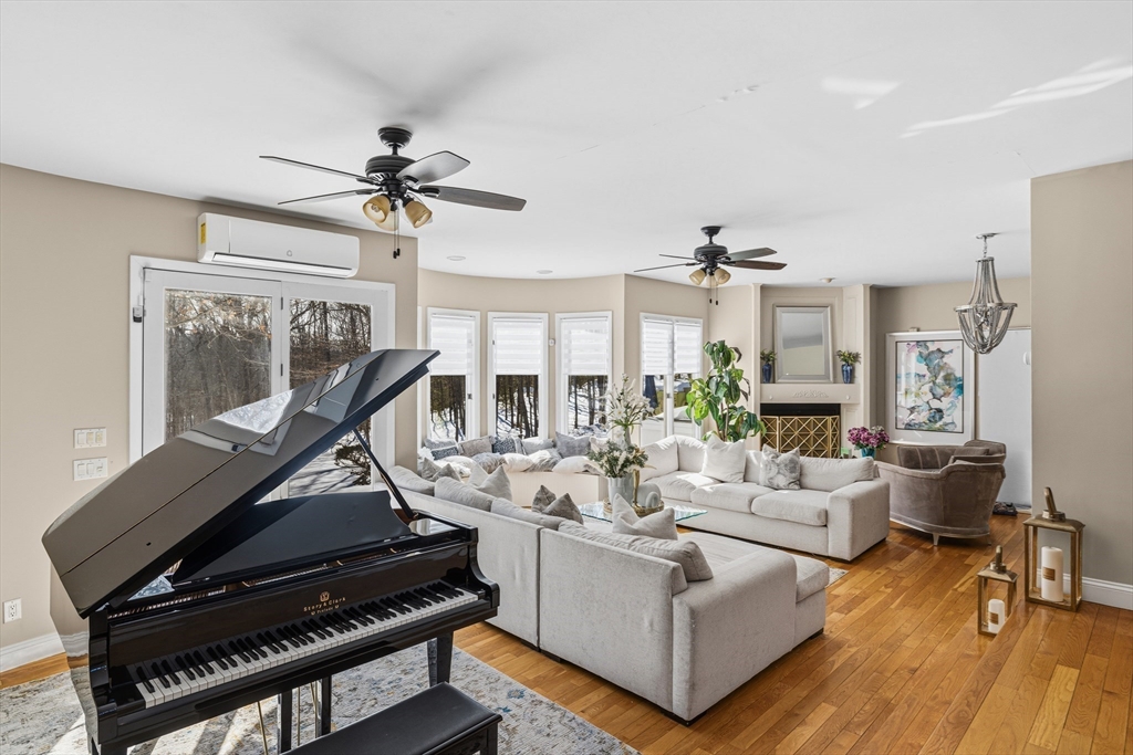 95 Ramshorn Road Dudley, MA 01571 - Photo 9 of 42 a living room with furniture a chandelier and a floor to ceiling window