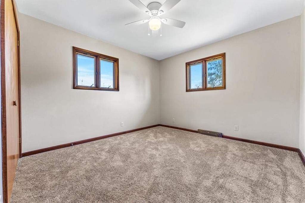 511 Mercer-New Wilmington Road Mercer, PA 16137 - Photo 20 of 30 an empty room with a chandelier fan and windows