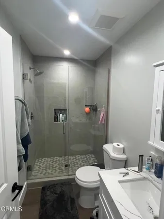 a bathroom with a sink toilet and shower